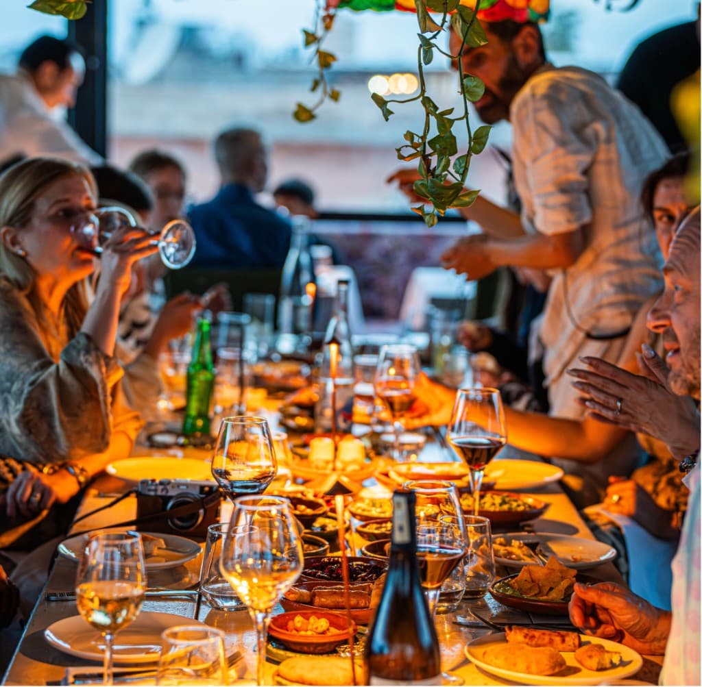 Large group enjoying a long table dinner together