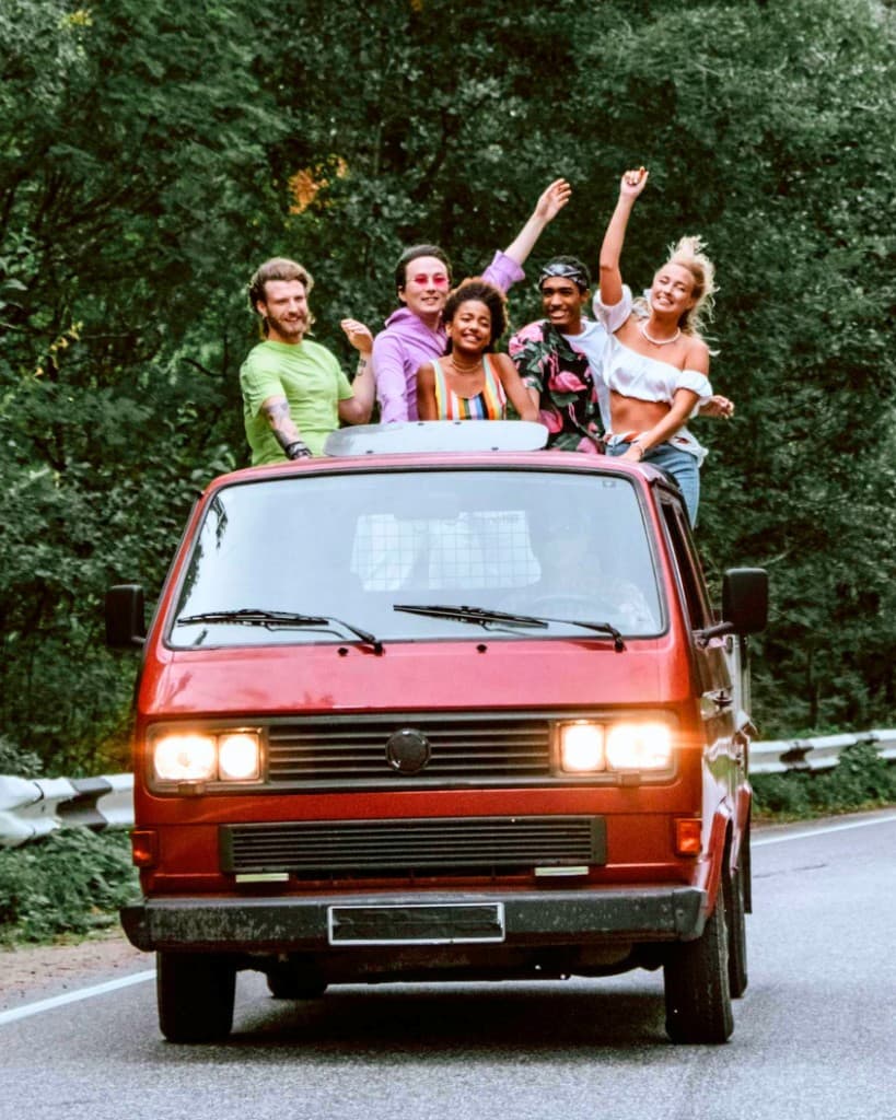 Friends on a road trip in a red van